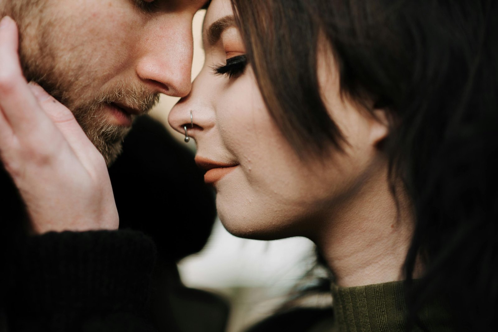 A tender close-up of a couple sharing a romantic and intimate moment outdoors, conveying love and connection.